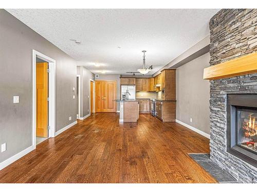 120-106 Stewart Creek Landing, Canmore, AB - Indoor With Fireplace