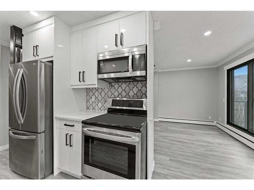 102-917 18 Avenue Sw, Calgary, AB - Indoor Photo Showing Kitchen With Stainless Steel Kitchen