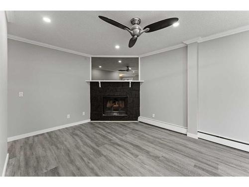 102-917 18 Avenue Sw, Calgary, AB - Indoor Photo Showing Living Room With Fireplace