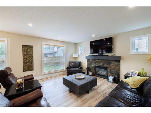 8 Canoe Road Sw, Airdrie, AB - Indoor Photo Showing Living Room With Fireplace