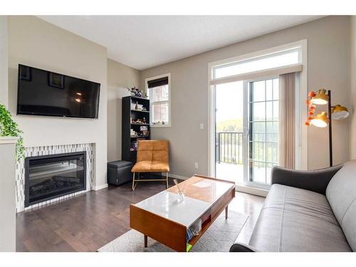 147 Ascot Point Sw, Calgary, AB - Indoor Photo Showing Living Room With Fireplace