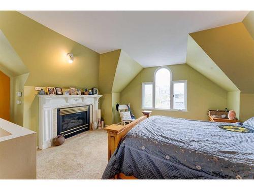68 6 Street Ne, Calgary, AB - Indoor Photo Showing Bedroom With Fireplace