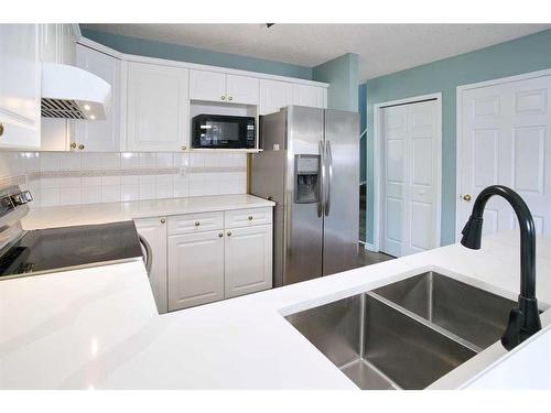 35 Bridlewood Avenue Sw, Calgary, AB - Indoor Photo Showing Kitchen With Double Sink