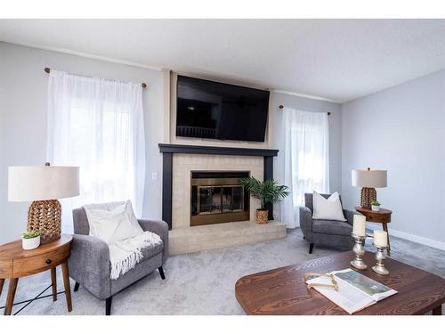 19 Dry Creek Bay, Airdrie, AB - Indoor Photo Showing Living Room With Fireplace
