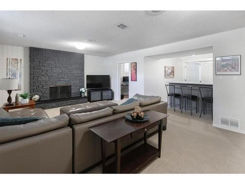 7211 Kananaskis Drive Sw, Calgary, AB - Indoor Photo Showing Living Room With Fireplace