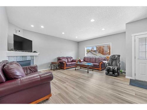108 Hawkmere Way, Chestermere, AB - Indoor Photo Showing Living Room With Fireplace