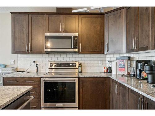 322-2400 Ravenswood View Se, Airdrie, AB - Indoor Photo Showing Kitchen With Upgraded Kitchen