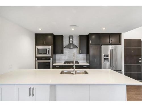 106-3320 3 Avenue Nw, Calgary, AB - Indoor Photo Showing Kitchen With Double Sink With Upgraded Kitchen