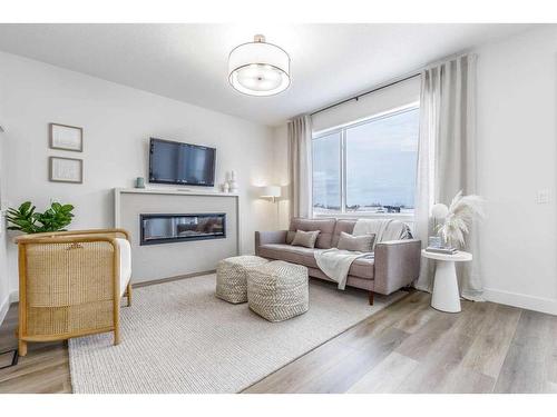 172 Emberside Hollow, Cochrane, AB - Indoor Photo Showing Living Room With Fireplace