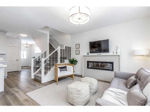 172 Emberside Hollow, Cochrane, AB - Indoor Photo Showing Living Room With Fireplace