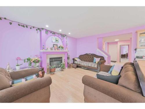 112 Saddlecrest Boulevard Ne, Calgary, AB - Indoor Photo Showing Living Room With Fireplace