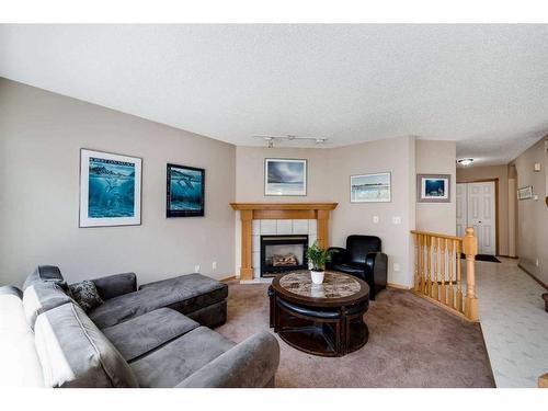 218 Arbour Butte Road Nw, Calgary, AB - Indoor Photo Showing Living Room With Fireplace