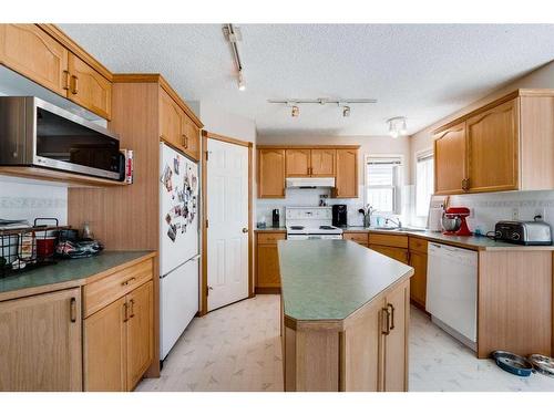 218 Arbour Butte Road Nw, Calgary, AB - Indoor Photo Showing Kitchen With Double Sink