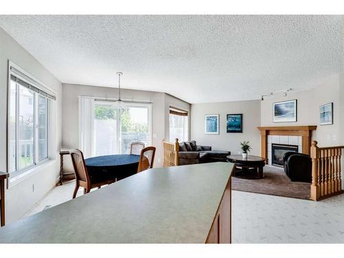 218 Arbour Butte Road Nw, Calgary, AB - Indoor With Fireplace