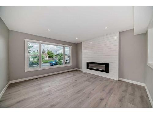 1439 Pensacola Way Se, Calgary, AB - Indoor Photo Showing Living Room With Fireplace