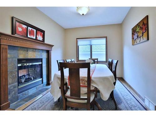 51 Hamptons Close Nw, Calgary, AB - Indoor Photo Showing Dining Room With Fireplace