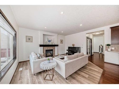 67 Panamount Circle Nw, Calgary, AB - Indoor Photo Showing Living Room With Fireplace