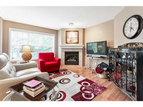 1201-7171 Coach Hill Road Sw, Calgary, AB - Indoor Photo Showing Living Room With Fireplace