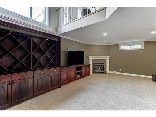 58 Arbour Butte Road Nw, Calgary, AB - Indoor Photo Showing Basement With Fireplace
