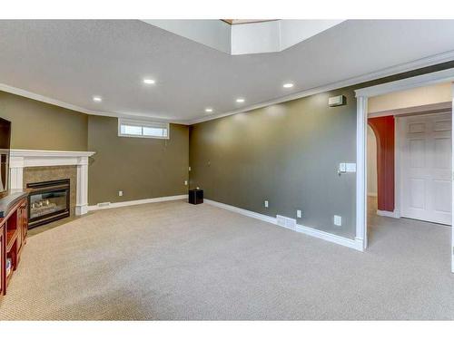 58 Arbour Butte Road Nw, Calgary, AB - Indoor Photo Showing Basement With Fireplace