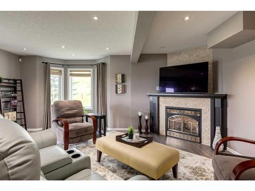 80 Buffalo Rub Place Nw, Airdrie, AB - Indoor Photo Showing Living Room With Fireplace