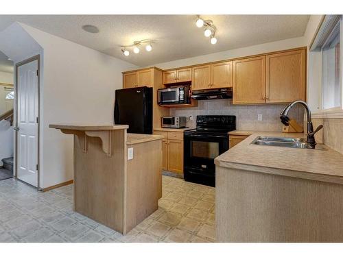 142 Cramond Circle Se, Calgary, AB - Indoor Photo Showing Kitchen With Double Sink