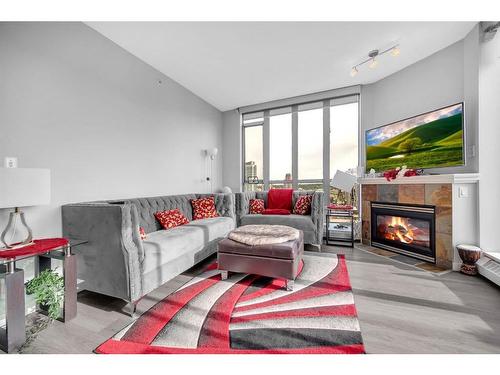 #2301-650 10 Street Sw, Calgary, AB - Indoor Photo Showing Living Room With Fireplace