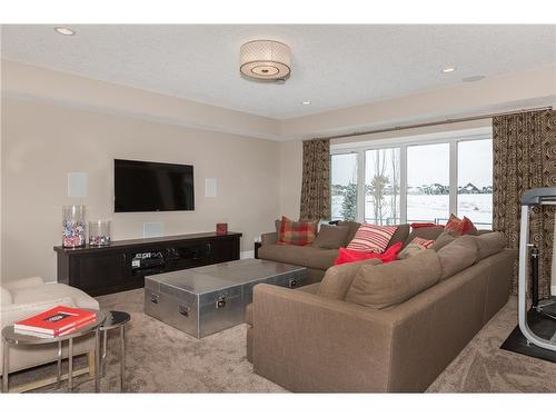 38 Waters Edge Drive, Heritage Pointe, AB - Indoor Photo Showing Living Room With Fireplace