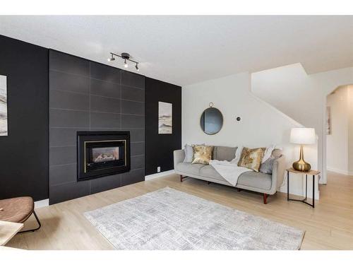 82 Riverbend Drive Se, Calgary, AB - Indoor Photo Showing Living Room With Fireplace
