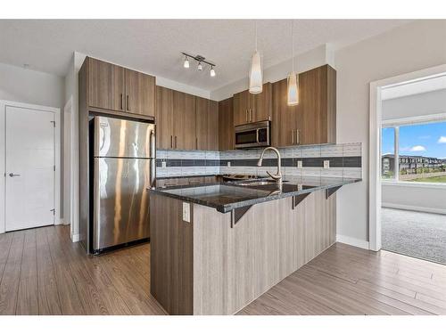 202-4 Sage Hill Terrace Nw, Calgary, AB - Indoor Photo Showing Kitchen With Stainless Steel Kitchen With Upgraded Kitchen