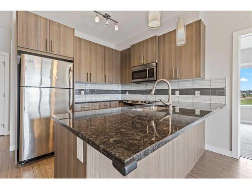 202-4 Sage Hill Terrace Nw, Calgary, AB - Indoor Photo Showing Kitchen With Stainless Steel Kitchen With Double Sink With Upgraded Kitchen