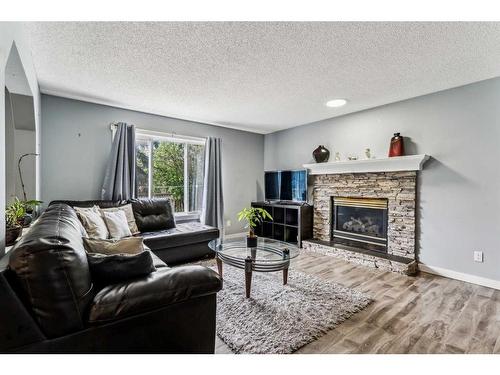 33 Applecrest Crescent Se, Calgary, AB - Indoor Photo Showing Living Room With Fireplace
