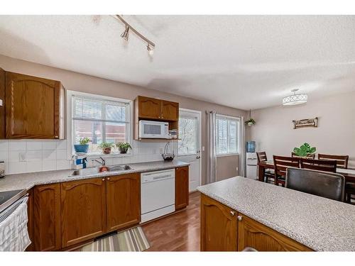 59-4 Stonegate Drive Nw, Airdrie, AB - Indoor Photo Showing Kitchen With Double Sink