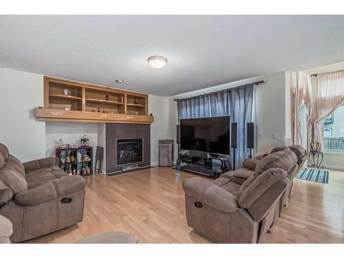 104 Panamount Manor Nw, Calgary, AB - Indoor Photo Showing Living Room With Fireplace