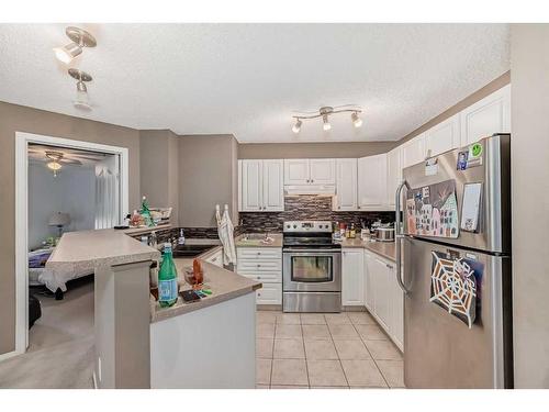 207-16 Country Village Bay Ne, Calgary, AB - Indoor Photo Showing Kitchen With Double Sink