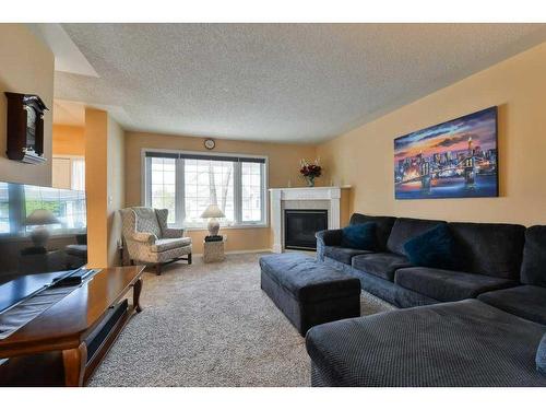 63 Sierra Morena Gardens Sw, Calgary, AB - Indoor Photo Showing Living Room With Fireplace