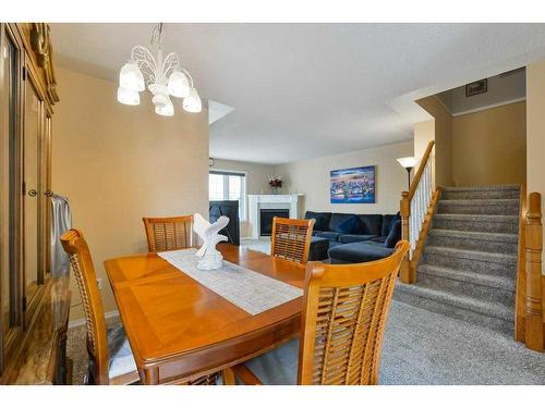 63 Sierra Morena Gardens Sw, Calgary, AB - Indoor Photo Showing Dining Room With Fireplace