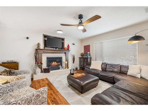 172 Woodstock Way Sw, Calgary, AB - Indoor Photo Showing Living Room With Fireplace