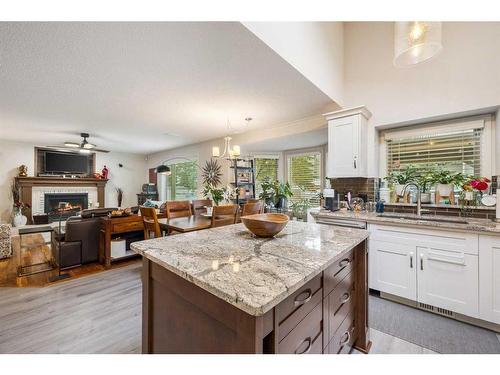 172 Woodstock Way Sw, Calgary, AB - Indoor Photo Showing Kitchen With Fireplace