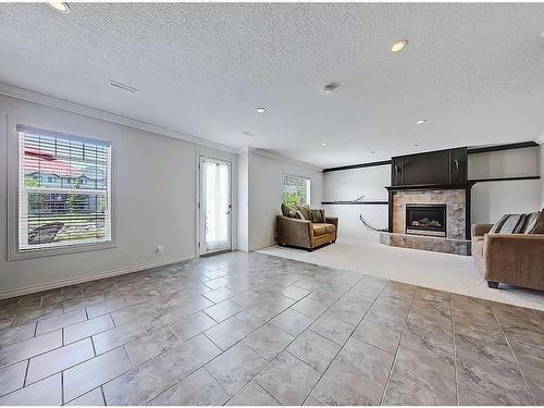 967 Bayside Drive Sw, Airdrie, AB - Indoor Photo Showing Other Room With Fireplace