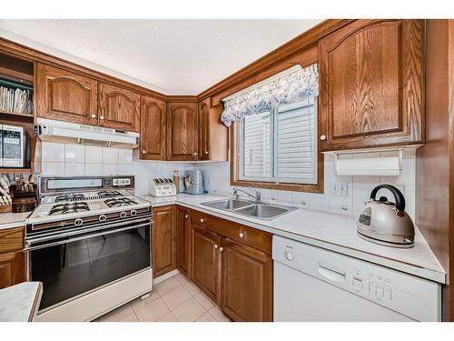 386 Millrise Drive Sw, Calgary, AB - Indoor Photo Showing Kitchen With Double Sink