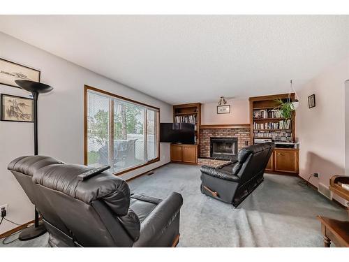 386 Millrise Drive Sw, Calgary, AB - Indoor Photo Showing Living Room With Fireplace