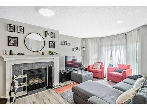 36 Cramond Drive Se, Calgary, AB - Indoor Photo Showing Living Room With Fireplace