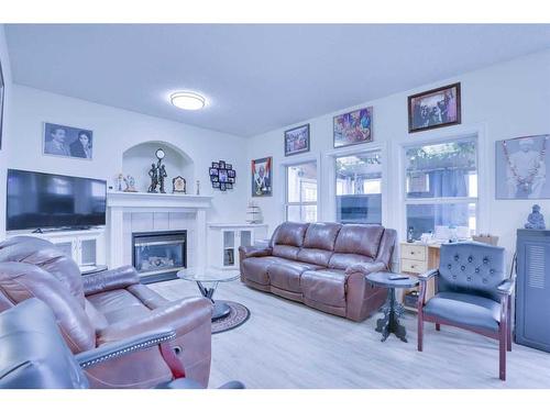 72 Coral Reef Close Ne, Calgary, AB - Indoor Photo Showing Living Room With Fireplace