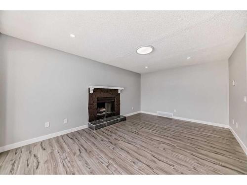 53 Templemont Drive Ne, Calgary, AB - Indoor With Fireplace