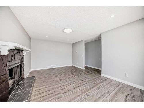 53 Templemont Drive Ne, Calgary, AB - Indoor With Fireplace