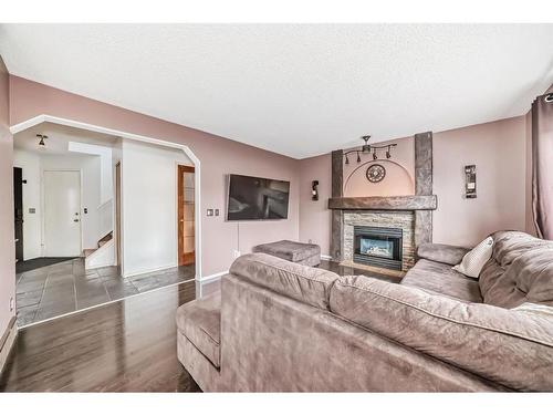 144 Riverglen Drive Se, Calgary, AB - Indoor Photo Showing Living Room With Fireplace