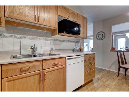 127 Sienna Park Green Sw, Calgary, AB - Indoor Photo Showing Kitchen With Double Sink