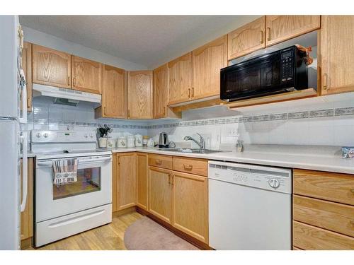 127 Sienna Park Green Sw, Calgary, AB - Indoor Photo Showing Kitchen With Double Sink