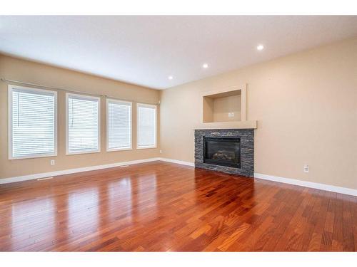 219 Panamount Circle Nw, Calgary, AB - Indoor Photo Showing Other Room With Fireplace